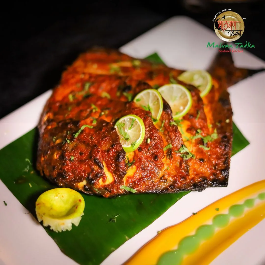 Whole tandoori pomfret on a banana leaf