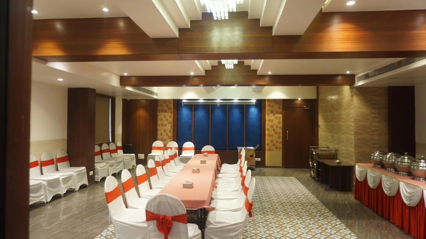 A banquet hall laid out with sashed chairs