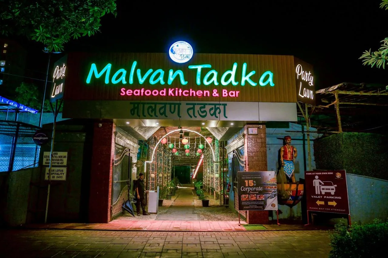 The neon-lit arch entrance and party lawn at night