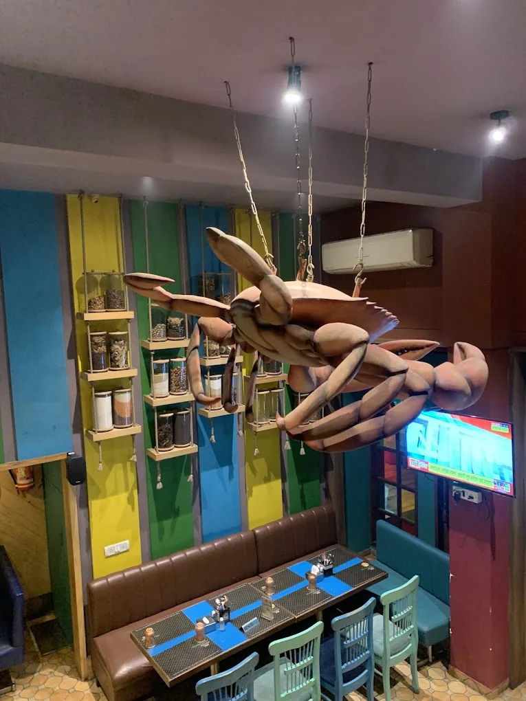 A giant crab sculpture above the dining room at Malvan Tadka