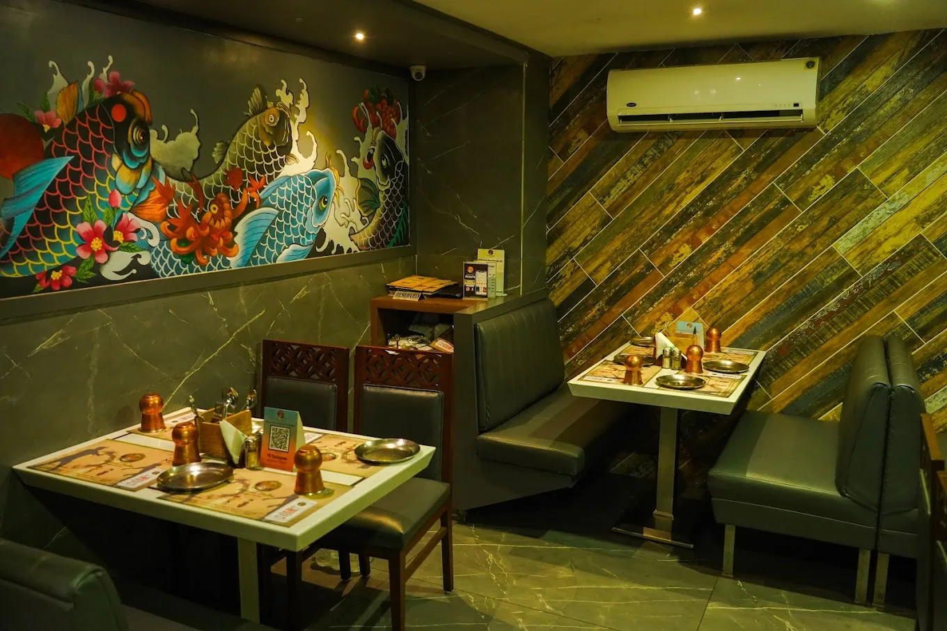 A koi mural beside a green marble booth